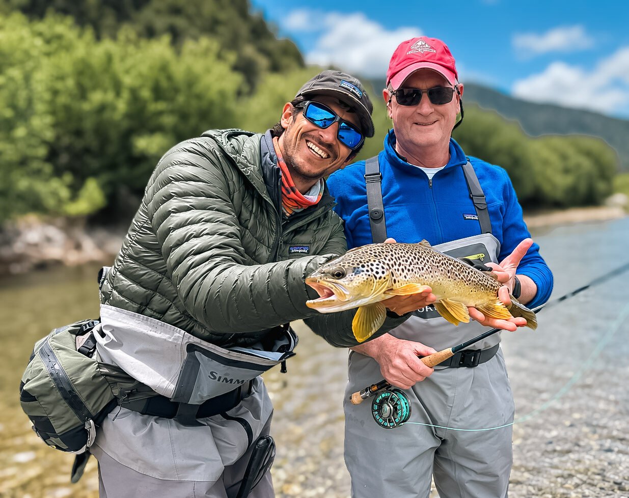 Fly fishing guide in Bariloche with guest and brown trout on the Manso River